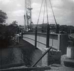 Lowering one side of the bridge into place