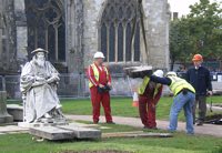 Workmen, have removed the statue from the plinth