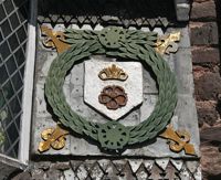 The coat of arms on the right side of the Tudor House